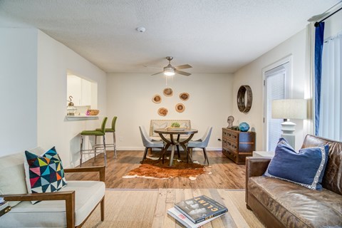 a living room with a couch and a table with chairs